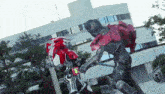 a man in a robot costume is fighting another man in a robot costume .