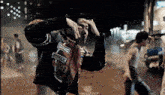 a man in a vans jacket holds his head