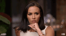 a woman with # mafs written on the bottom of her screen