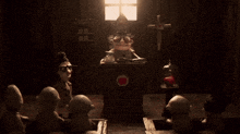 a group of cartoon characters are sitting around a table with a cross on it