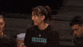 a girl wearing a black shirt that says black