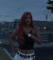 a woman with red hair and a watch on her wrist stands in front of a building