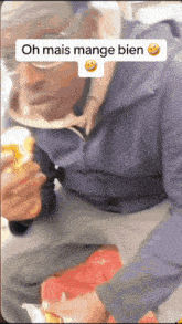a man eating a hamburger with the words oh mais mange bien written above him