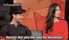 a man and a woman are sitting next to each other on a couch and talking about barcelona .