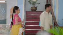 a man and a woman are walking down the stairs