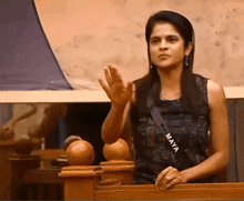 a woman with the name maya on her shirt waves her hand