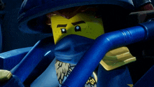 a close up of a lego figure with a yellow face and blue arms