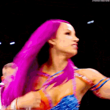 a woman with pink hair is wearing a blue and orange outfit