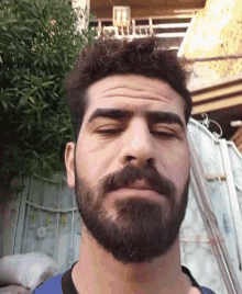 a man with a beard is making a funny face