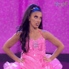 a woman in a pink dress with the word talent on the bottom right corner