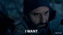 a man with a beard wearing a beanie and a jacket with the words to stay home written below him