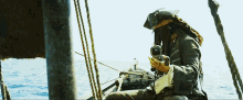 a man in a pirate costume is sitting on a boat looking through binoculars
