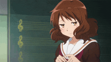 a girl with a sad look on her face stands in front of a blackboard with treble clef symbols