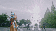 a group of people are standing in a parking lot with a giant robot behind them