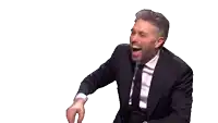a man in a suit and tie is dancing with his hands in the air