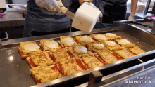 a bunch of food is being cooked on a griddle and the words made in animotica are on the bottom
