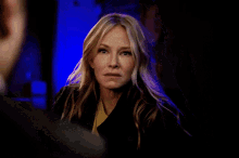 a woman with blonde hair is looking at a man