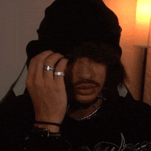 a man with a nose ring and a watch on his arm