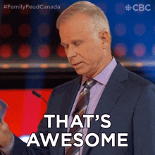 a man in a suit and tie is giving a speech and says that 's awesome