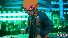 a gif of a man wearing a bandana and a mask with the words gif jif below him