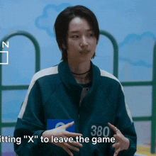 a woman is wearing a green jacket with the number 380 on it