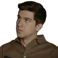 a man in a brown shirt looks to his right
