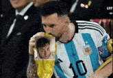 a soccer player wearing a blue and white jersey with the number 10 on it