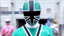a green power ranger with a cross on his mask