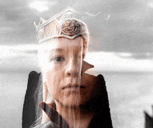 a woman with a crown on her head has a reflection of her face