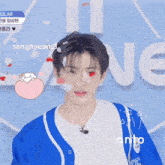 a young man in a blue and white shirt is surrounded by confetti
