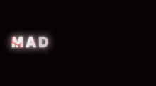a neon sign that says mad tes beau on a dark background