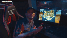 a man in a hat is playing a video game on a computer screen