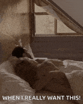 a man and woman laying on a bed with the words " when i really want this " on the bottom