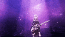 a girl playing a guitar on a stage with purple lights behind her