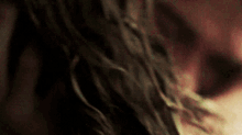 a close up of a woman 's face and hair in a dark room