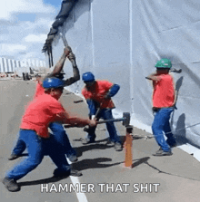 a group of construction workers are hammering a hole in a wall with a hammer that says hammer that shit .