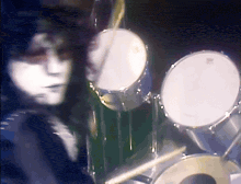 a person playing drums with a drum set that says evans on it