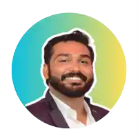 a man with a beard is smiling in front of a blue and yellow circle