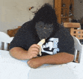 a man wearing a mask is eating a banana and his shirt says ice