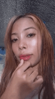 a close up of a woman 's face with a red lip