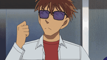 a young man wearing sunglasses and a red shirt