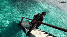 a person climbs a set of stairs into a body of water with the words thisisakate on the bottom