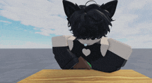 a cartoon character with black hair and cat ears sits at a table