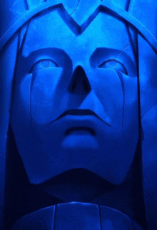 a statue of a man 's face is lit up with blue light