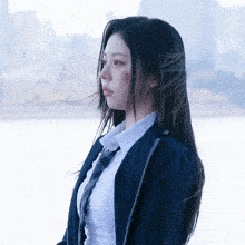 a woman in a suit and tie has a scratch on her face