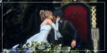 a man and a woman are kissing while sitting on a chair
