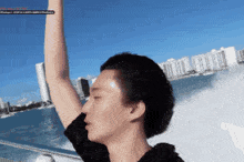 a man on a boat with his arm up in the air