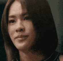 a close up of a woman 's face with a serious look on her face