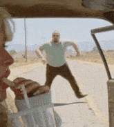 a woman is drinking through a straw while a man stands behind her on the side of the road .