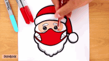 a person is drawing santa wearing a face mask